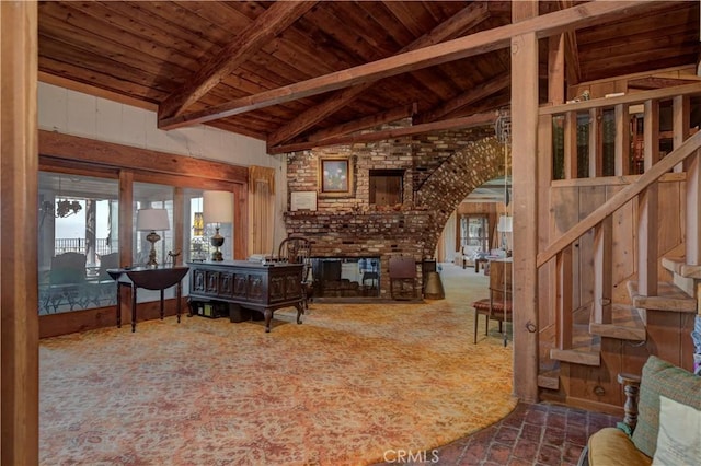 living room with lofted ceiling with beams, a brick fireplace, and wooden ceiling