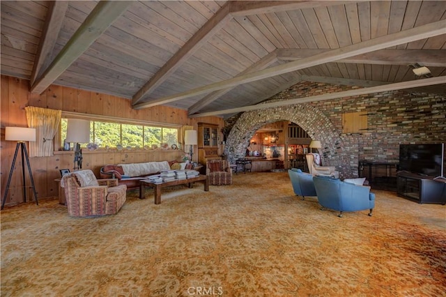 unfurnished living room with lofted ceiling with beams, carpet flooring, wood ceiling, and wood walls