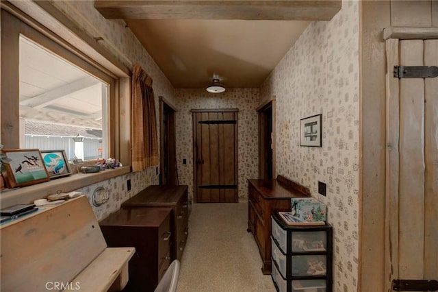 corridor featuring light carpet and beamed ceiling