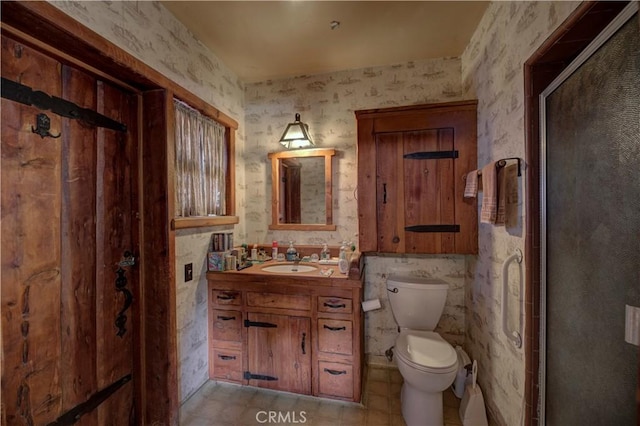 bathroom with vanity, toilet, and an enclosed shower