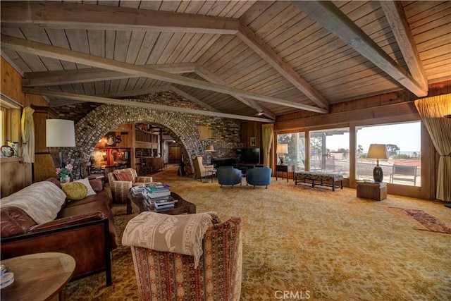 living room with wood ceiling, carpet floors, wooden walls, and lofted ceiling with beams