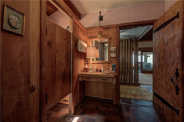 interior space with decorative light fixtures and wooden walls