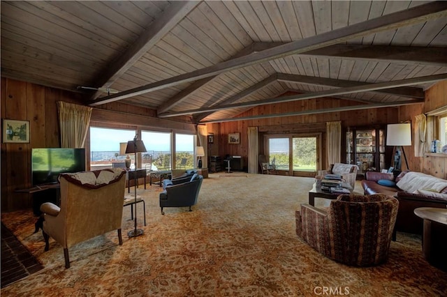 carpeted living room featuring wood ceiling, a wealth of natural light, wooden walls, and lofted ceiling with beams