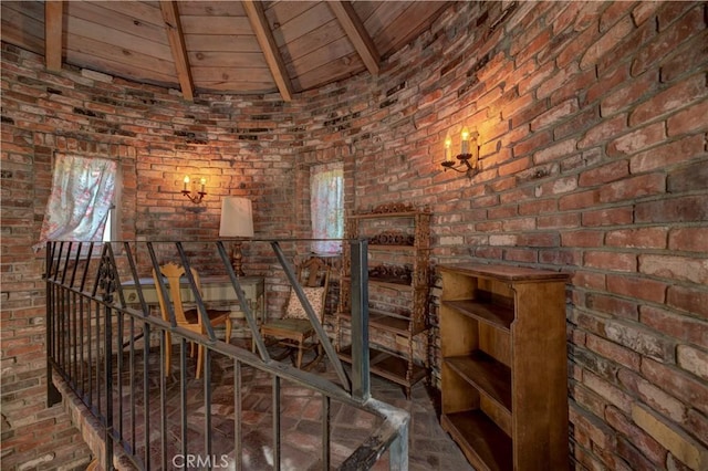 wine area featuring wood ceiling, lofted ceiling with beams, and brick wall