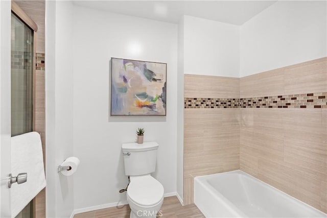 bathroom featuring hardwood / wood-style flooring, shower with separate bathtub, and toilet