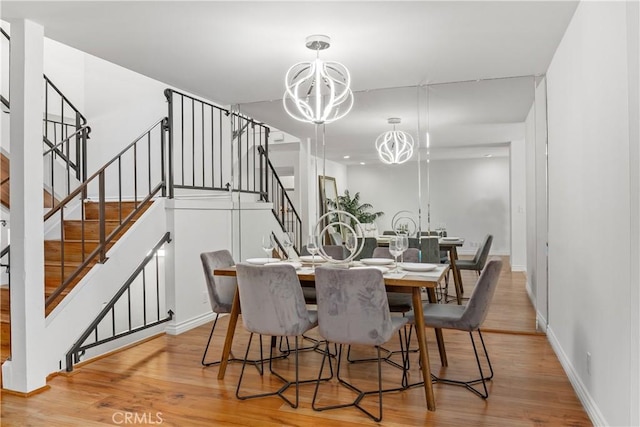 dining room with a chandelier and light hardwood / wood-style floors