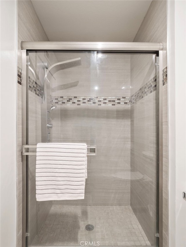 bathroom with a shower with shower door