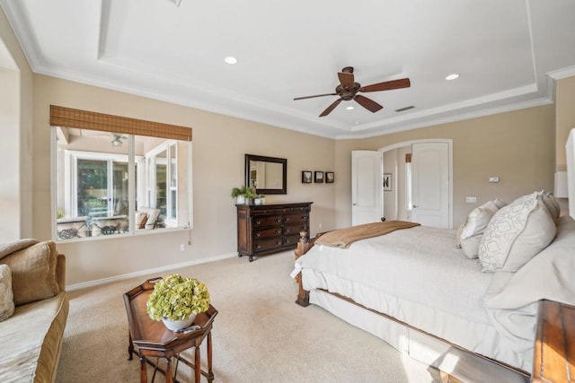 bedroom with crown molding, a raised ceiling, and light carpet