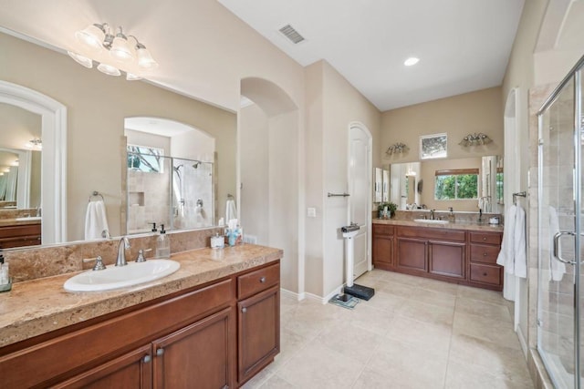 bathroom featuring tile patterned floors, vanity, and a shower with door