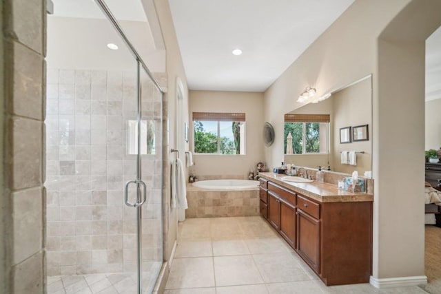 bathroom featuring vanity, shower with separate bathtub, and tile patterned flooring