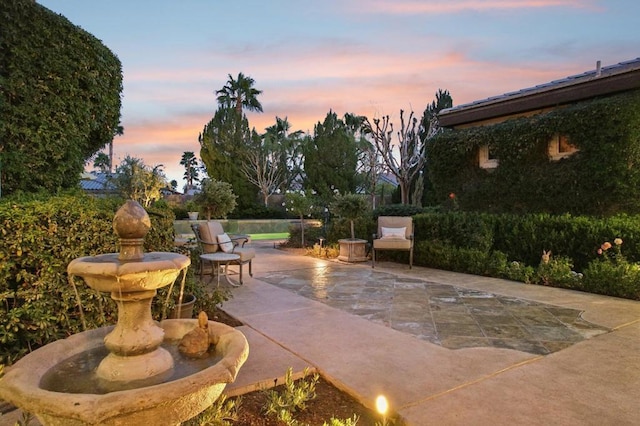 view of patio terrace at dusk