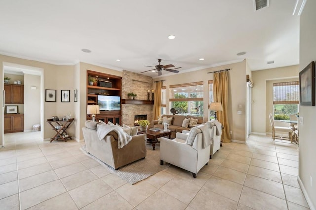 living room featuring ornamental molding, a healthy amount of sunlight, light tile patterned floors, and a fireplace