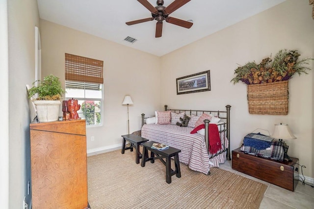 tiled bedroom featuring ceiling fan