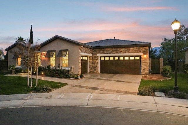 view of front of house featuring a garage and a lawn