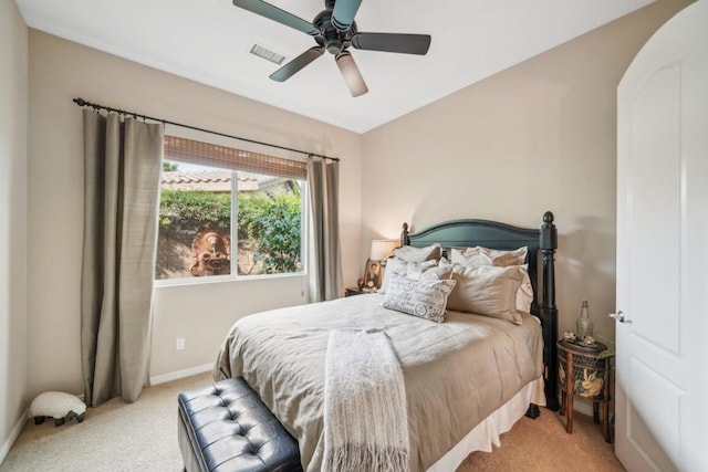 bedroom with ceiling fan and light carpet