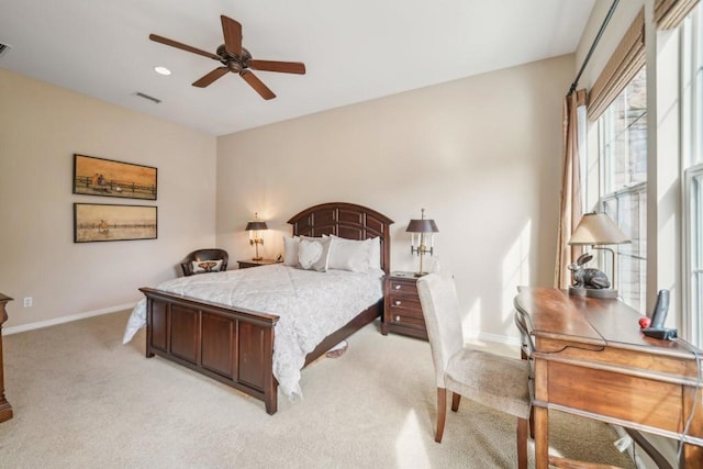 bedroom featuring light colored carpet and ceiling fan