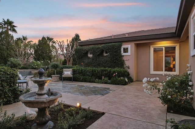 view of patio terrace at dusk