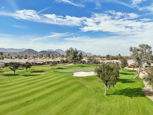 surrounding community featuring a mountain view and a lawn