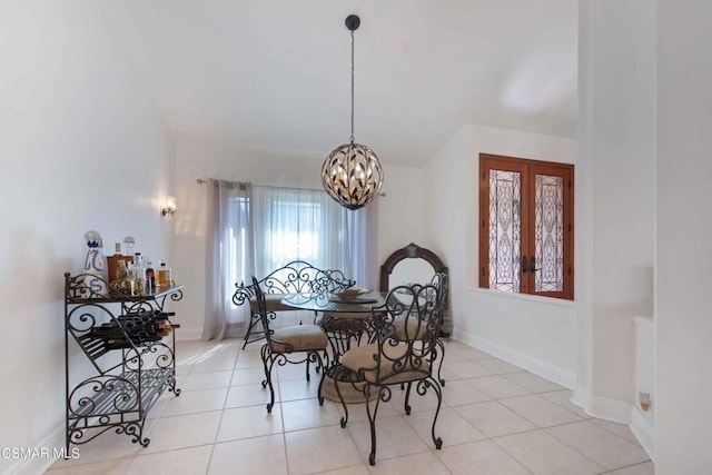 tiled dining space with a notable chandelier