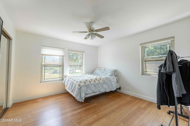 bedroom with ceiling fan and light wood-type flooring