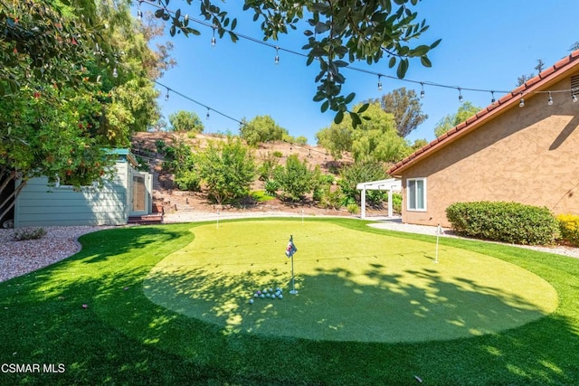 view of yard with a pergola and an outdoor structure