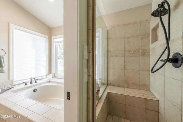 bathroom featuring independent shower and bath and lofted ceiling