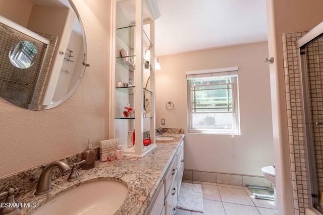 bathroom featuring vanity, tile patterned flooring, toilet, and walk in shower