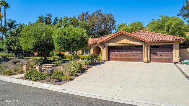 mediterranean / spanish-style home with a garage