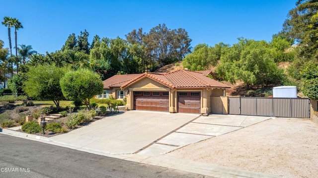 mediterranean / spanish-style house with a garage