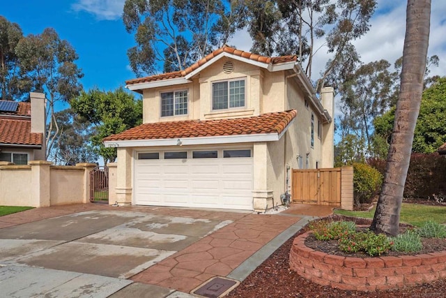 mediterranean / spanish-style home featuring a garage