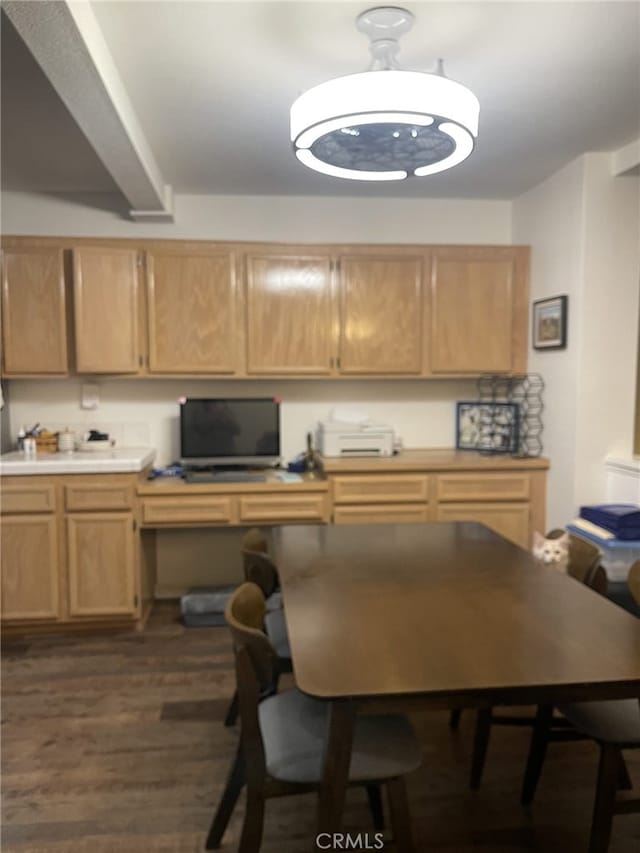 kitchen featuring light brown cabinets, built in desk, and dark hardwood / wood-style flooring