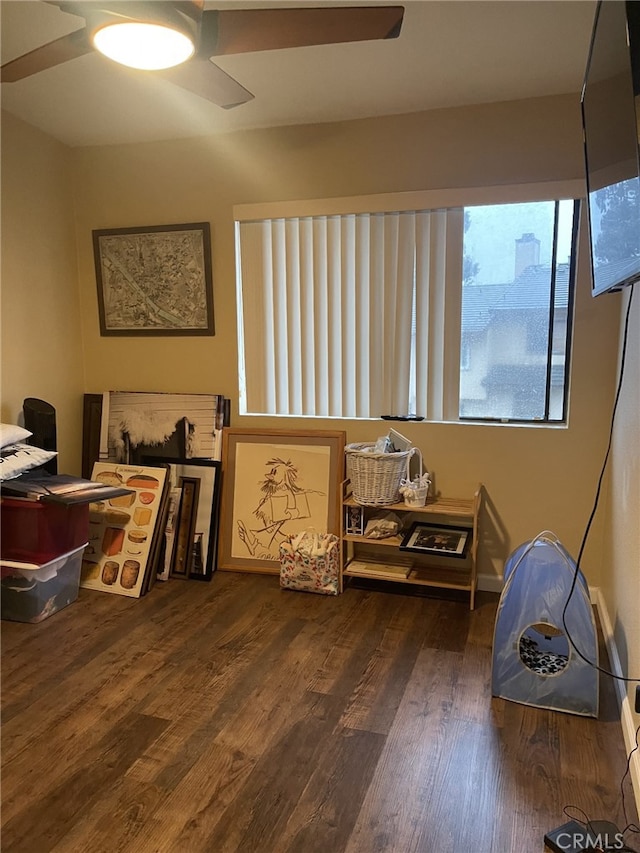 interior space with ceiling fan and dark hardwood / wood-style flooring