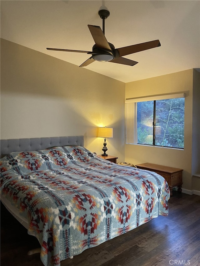 bedroom with dark hardwood / wood-style floors and ceiling fan