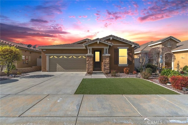 view of front facade with a yard and a garage