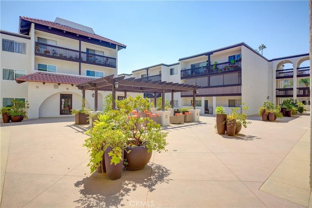 surrounding community with a pergola and a patio