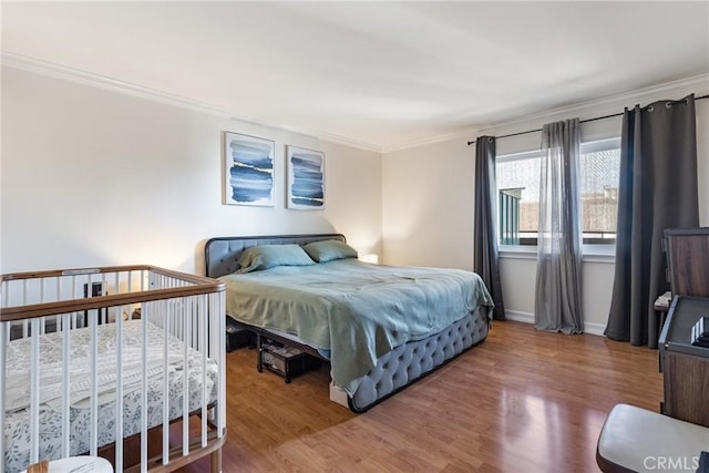 bedroom featuring hardwood / wood-style flooring and ornamental molding