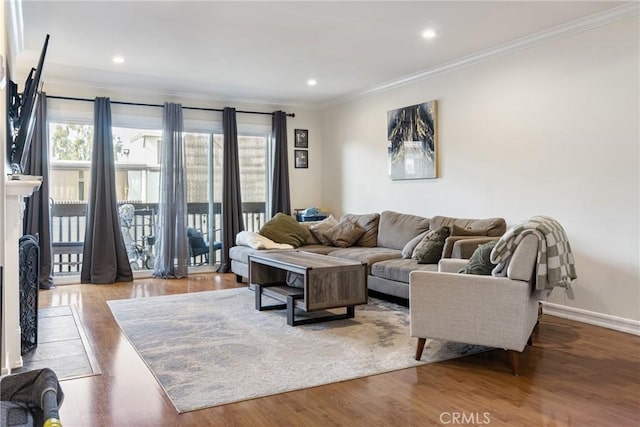 living room featuring hardwood / wood-style flooring and ornamental molding