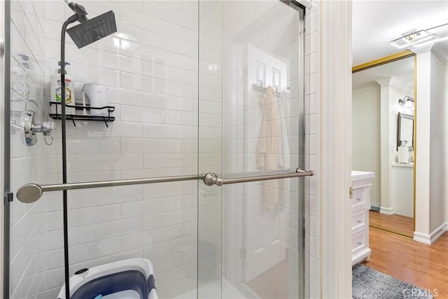 bathroom with hardwood / wood-style flooring and a shower with door