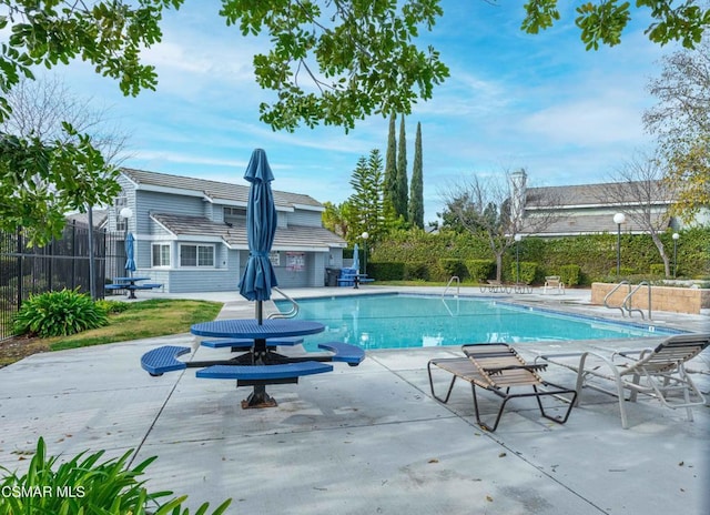 view of swimming pool featuring a patio area