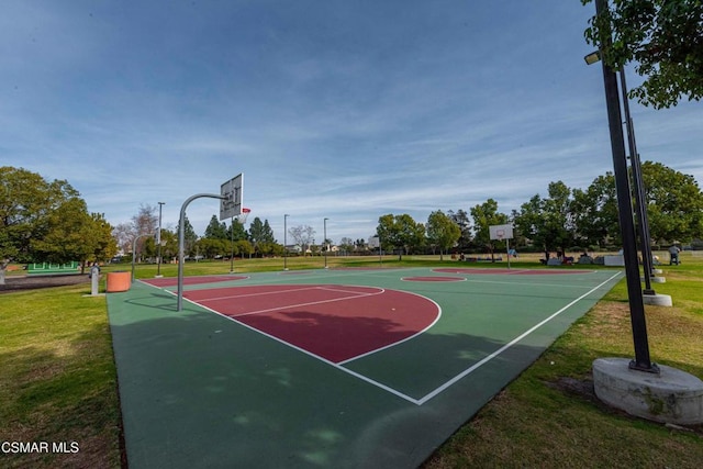 view of sport court with a yard