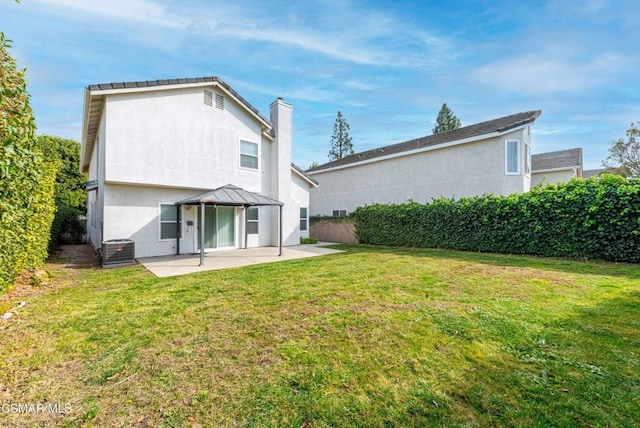 back of property with a yard, a gazebo, and a patio area