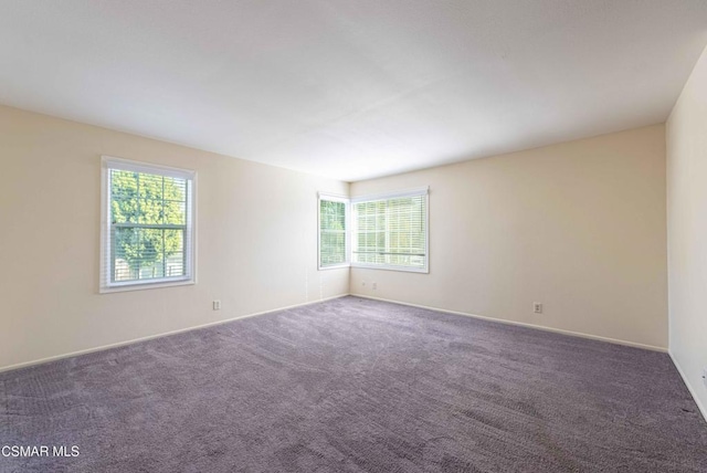 empty room featuring dark colored carpet