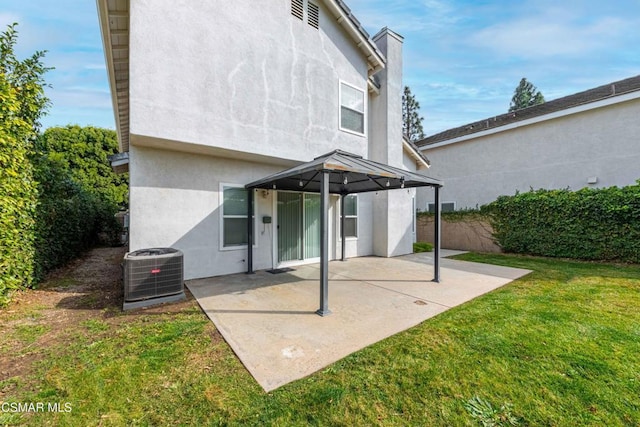 back of property featuring a patio, a yard, and central air condition unit