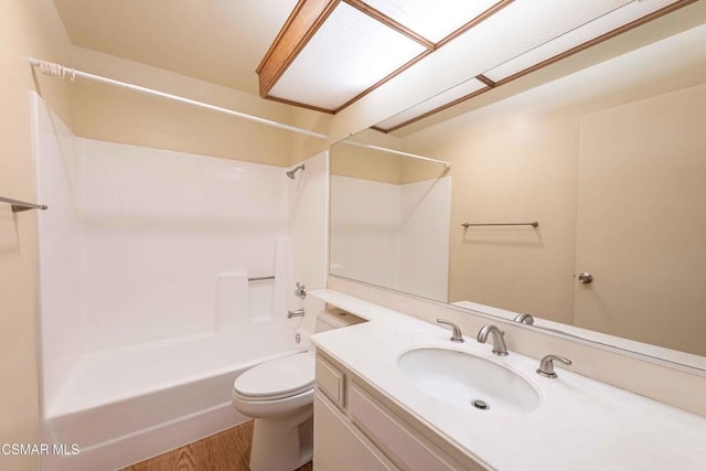 full bathroom featuring washtub / shower combination, vanity, toilet, and hardwood / wood-style floors