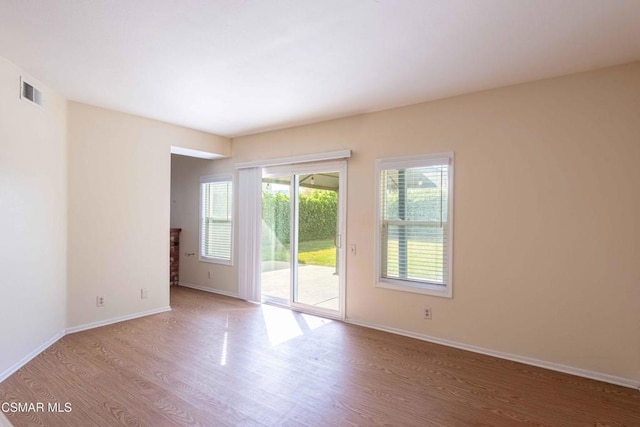 empty room with hardwood / wood-style floors