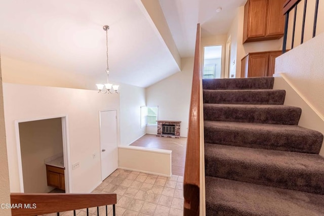 stairway featuring lofted ceiling, tile patterned flooring, and a notable chandelier