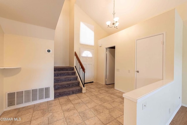 entrance foyer with a notable chandelier and high vaulted ceiling