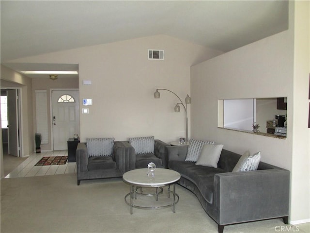 living room featuring lofted ceiling and light carpet