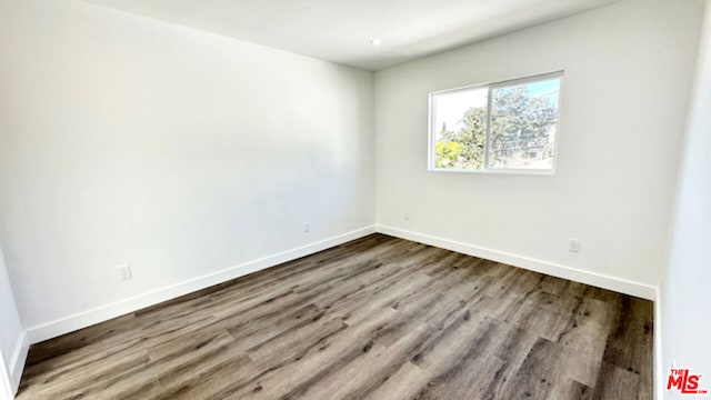 empty room with hardwood / wood-style floors