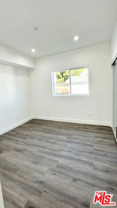 unfurnished room featuring dark hardwood / wood-style flooring